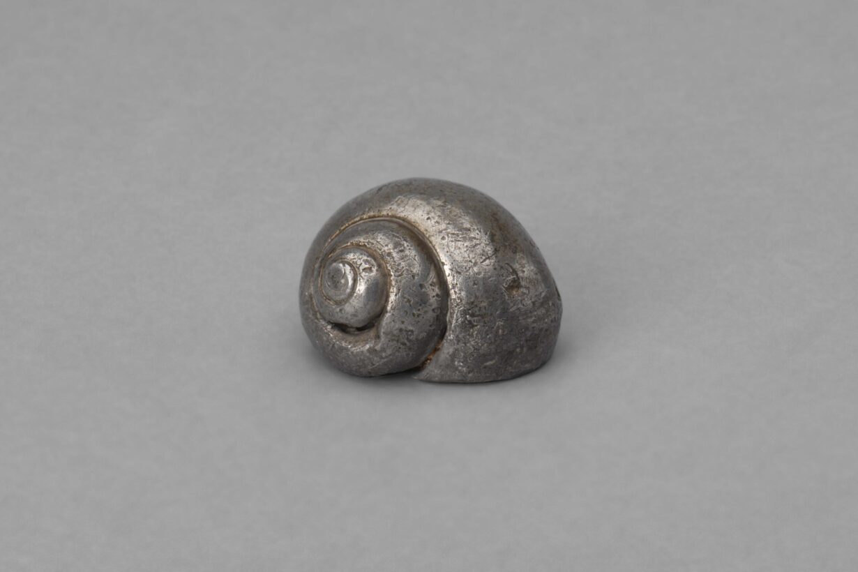 This is a picture of the metal snail shell that C.F. Ramuz kept on his desk. It shows signs of wear.